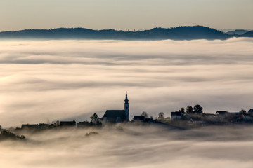 Frauenberg church and other surrounding houses emerging from thick fog