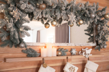 Burning candles on wooden shelf at home. Christmas interior