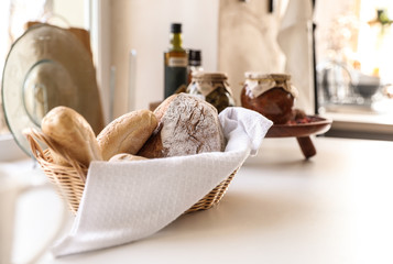 Fototapeta na wymiar Baked goods on white table in stylish kitchen