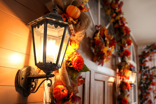House decorated for traditional autumn holidays, focus on vintage outdoor light