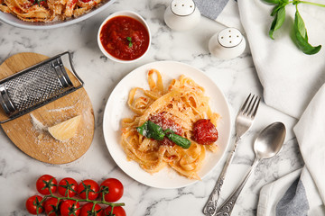 Flat lay composition with tasty pasta on white marble table