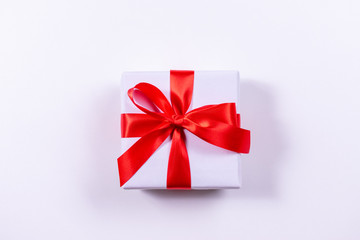 Christmas gift with red bow on white background. Xmas template. Happy New Year. Boxing Day.