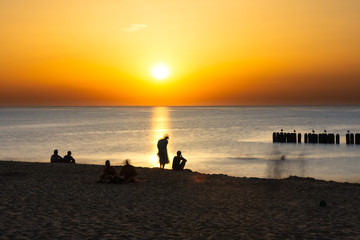 People on the beach during a beautiful sunset