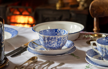 Old fashioned table set for tea with range