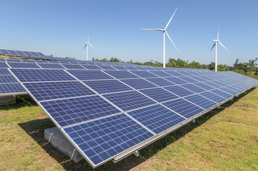 Solar panels and wind turbines generating electricity is solar energy and wind energy in hybrid...