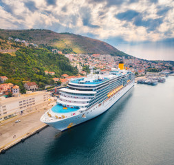 Aerial view of cruise ship in harbor. Top view of beautiful large ships and boats at sunny day....
