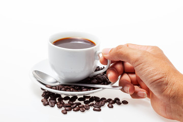 Male hand holding white coffee cup and coffee beans on white background
