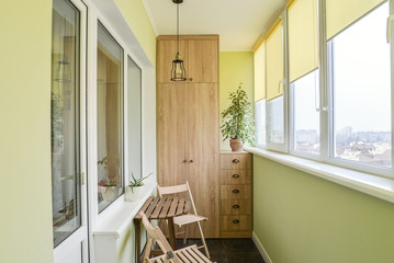 Interior of balcony with green walls, sitting area