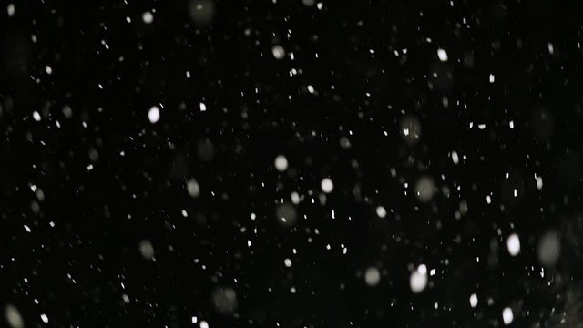 Falling snow in the dark, white snowflakes overlay, useful for vfx overlay for motion graphics