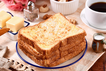 Golden brown french toasts on white plate.  