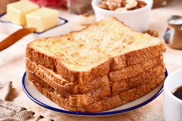 Golden brown french toasts on white plate.  