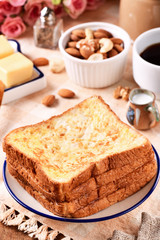 Golden brown french toasts on white plate.  