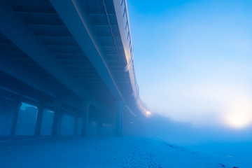 Bridge. Winter fog. Bridge over the river bottom view. Bridgework piers. The construction of...