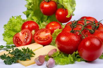 Fototapeta na wymiar cherry tomatoes on lettuce leaves on white background