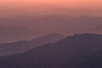 The blurred natural background of colorful twilight in the evening, on the high mountains, with many forests, provide fresh air and preserve the ecology.