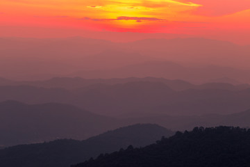 The blurred natural background of colorful twilight in the evening, on the high mountains, with many forests, provide fresh air and preserve the ecology.
