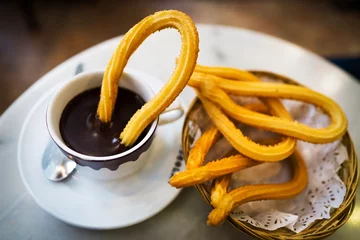  This image captures shows tradition and delicious fresh churros along side hot chocolate at a cafe in Spain © Gypsy Picture Show