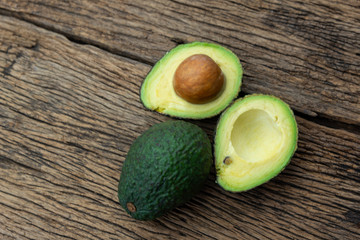 Avocado fruit on wooden background.