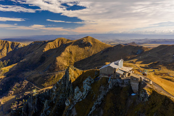 Aerial view of Pic du Sancy and light clouds after dawn. France in the fall