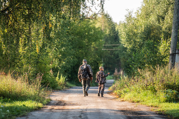 father pointing and guiding son on first deer hunt
