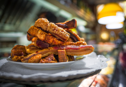 This image capture shows a delicious pile of torreznos pork belly pieces on display at an eatery