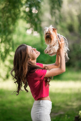 Obraz premium Beautiful woman play with dog in the park.