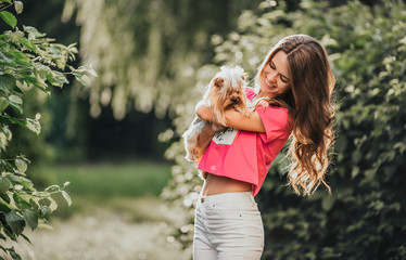 Beautiful woman play with dog in the park.