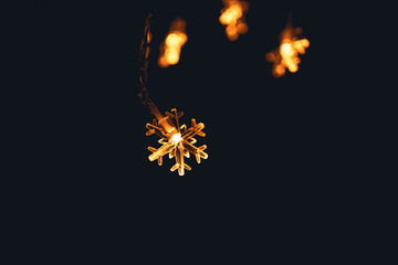 Obraz premium winter - A small light shaped like an orange snowflake at night