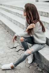Beautiful girl posing in the street. Urban style. Street fashion.