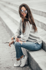 Beautiful girl posing in the street. Urban style. Street fashion.