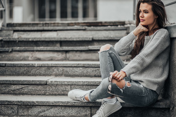 Beautiful girl posing in the street. Urban style. Street fashion.