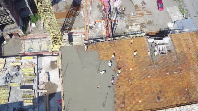 Concreting of last floor at building construction site. Aerial view.