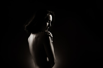 Slim Sexy woman in Black White Monotone sensual post short black hair turn shape body, Beautiful Fashion Model posing naked and cover with arms legs, studio lighting dark background back rim light