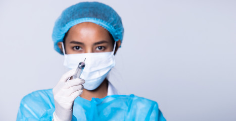 Fototapeta na wymiar Asian Beautiful Doctor Nurse woman in safety blue uniform with stethoscope hygiene helmet, rubber gloves syringe, mask in Medical hospital, studio lighting gray background isolated, collage group 360