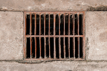 Rusty ruin metal sewage grate iron drainage cover on street top view