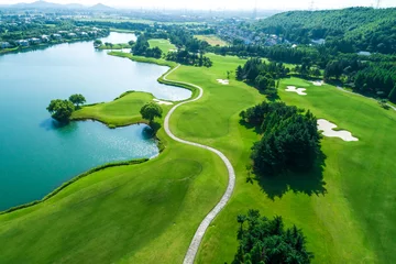 Foto op Plexiglas Aerial view of golf course and water © ABCDstock