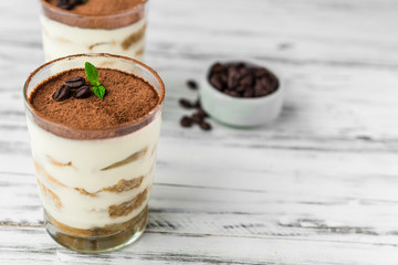 Close up of a traditional Italian tiramisu cake sweet dessert on white background