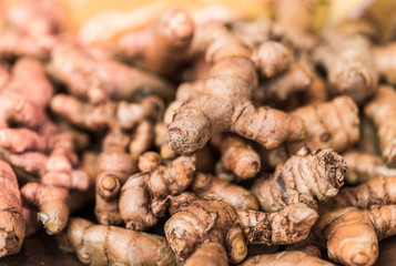Turmeric roots on display at a farmers market, selective focus