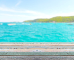 Fototapeta na wymiar Wood table top with blurred nature scene tropical beach