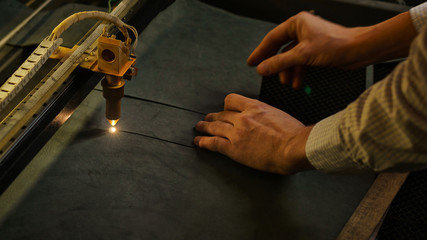 Laser cutting beam artificial leather High precision. Modern machine industrial technology of...