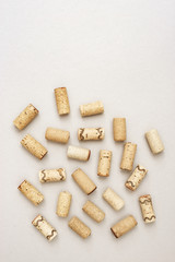 Minimal trendy concept with corks from wine bottles on lignt paper background with copy space. Flat lay for wine bar, winery, restaurant, wine list.