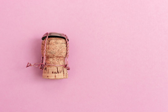 Women character from cork of champagne wine and metal muselet on pink colored background. Celebration or hen party concept theme.
