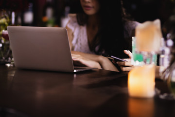 Asia woman using laptop computer working,playing with happy.