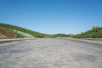 Dust covered asphalt road with sky horizon perspective landscape