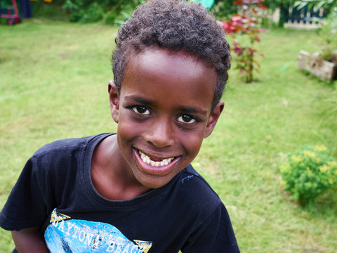 Portrait of a cheerful smiling black boy with missing teeth