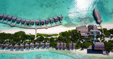 Luxurious bungalows over tranquil lagoon fully booked on summer by tourists coming from all countries