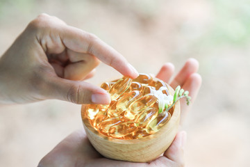 hand hold fish oil or herbal oil for healthy eating 