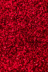 Red glitter texture. Festive sparkling sequins background closeup. Wpaper for Valentine, New Year or Christmas Holidays.