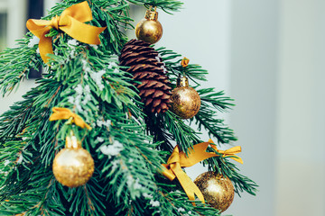 Green fir tree with golden balls. Christmas wallpaper.