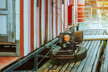 The old electricity generator for floating wooden raft house by using towing boat.